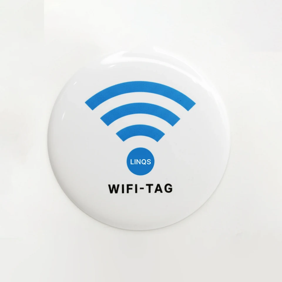 Actual white 50 mm LINQS WiFi Tag, with a blue Wi-Fi symbol and glossy epoxy dome